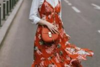 a bright and cool look with a white shirt, an orange floral print midi dress, white sneakers and an orange bag for a summer to fall wedding