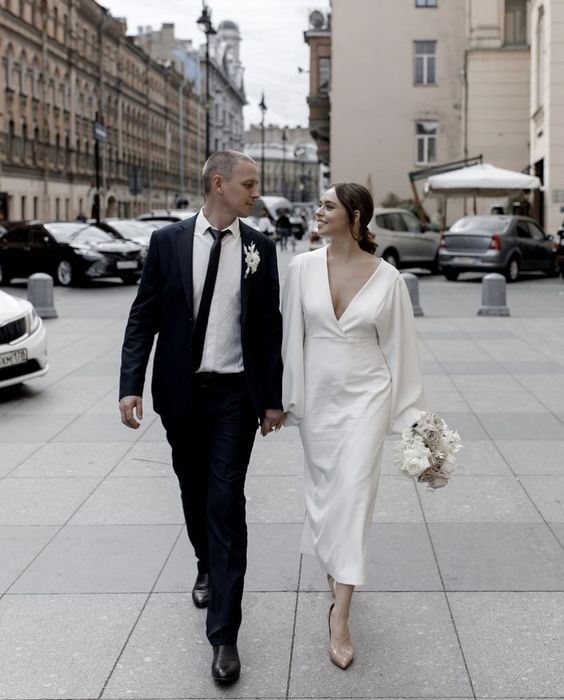 a casual midi wedding dress with a deep V-neckline and nude shoes is a cool and simple idea for a wedding