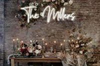 a chic industrial wedding space with shabby brick walls finished with refined furniture, luxurious florals and black candles