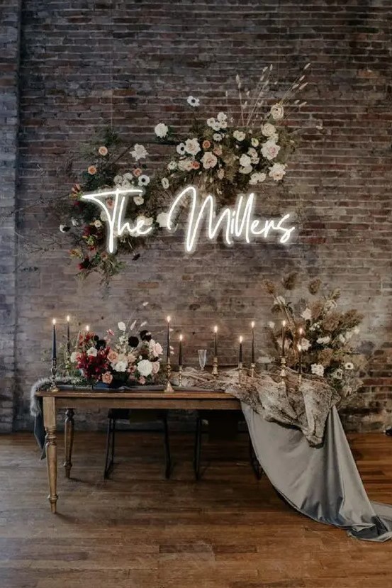 a chic industrial wedding space with shabby brick walls finished with refined furniture, luxurious florals and black candles