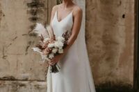 a classic slip wedding dress is a very minimal option, and it’s always in trend, accessorize it with a cool veil