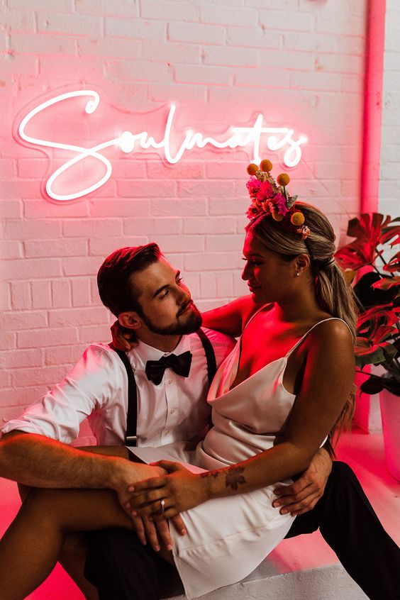 a cool calligraphy neon sign in pink is a lovely solution for a modern wedding, it looks chic and cool