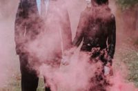 a gorgeous Halloween wedding photo done with red smoke is just jaw-dropping