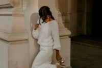 a gorgeous casual winter bridal look with a white sweater with a bateau neckline, a white mermaid skirt with a train and silver shoes