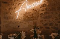 a laconic neon sign on the wall will be a nice and chic idea for a modern wedding, it can be used in any part of your wedding venue