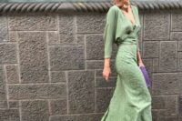 a lovely wedding guest ensemble with a green wrap up blouse, a green printed maxi skirt, gold shoes and a purple clutch