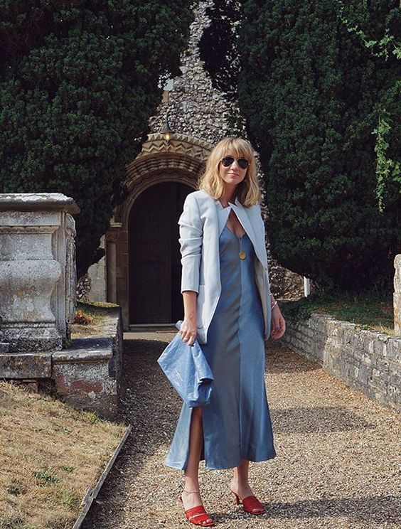 a lovely wedding guest look with a blue midi slip dress, a white blazer, red mules and a blue clutch for spring