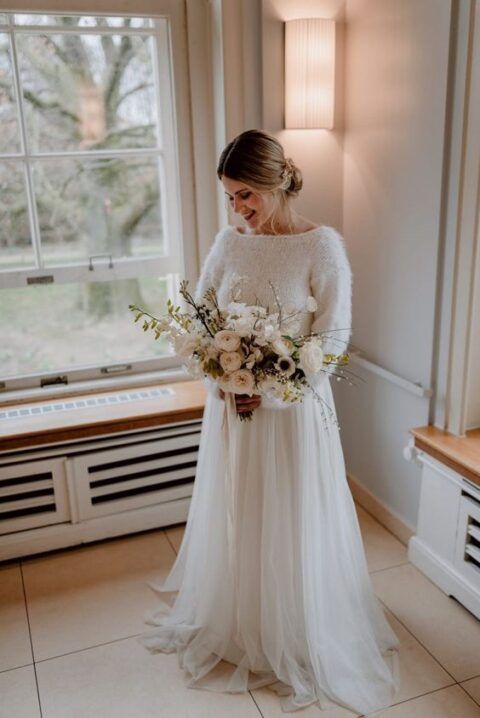 a lovely winter bridal look with a white sweater and a tulle layered skirt with a train is amazing and easy to repeat