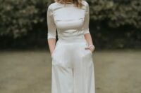a modern elegant bridal look with a silk crop top with a high neckline and short sleeves and palazzo pants plus strands of pearls