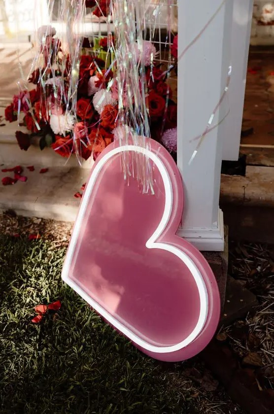 a neon heart sign is a lovely decoration for a wedding, it can match any modern wedding decor