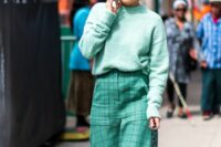 a pale green sweater, a green windowpane midi skirt, white boots, a teal bag are a cool look for a fall or winter wedding