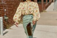 a pretty and elegant vintage-inspired wedding guest look with a tan floral blouse with puff sleeves, mint-colored pants, white shoes and a brown bag