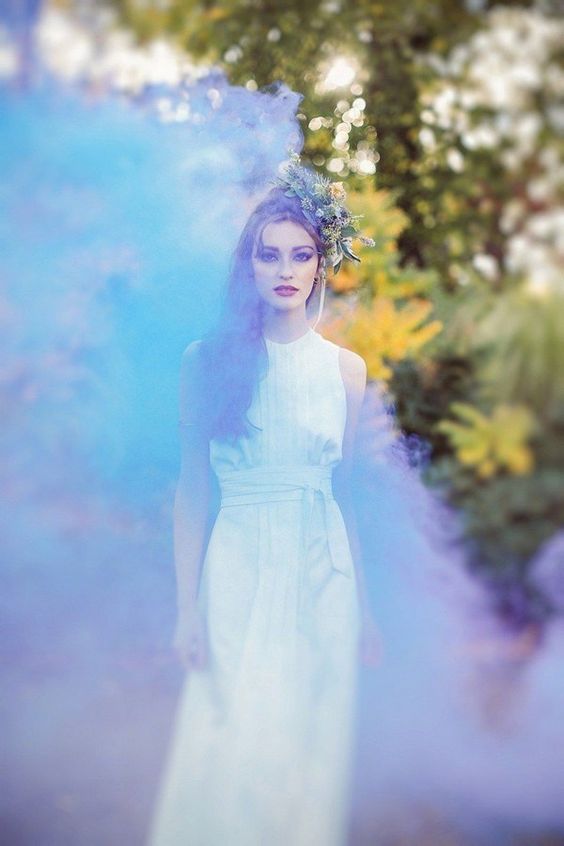 a unique and bold bridal portrait done with green and purple smoke to make it magical
