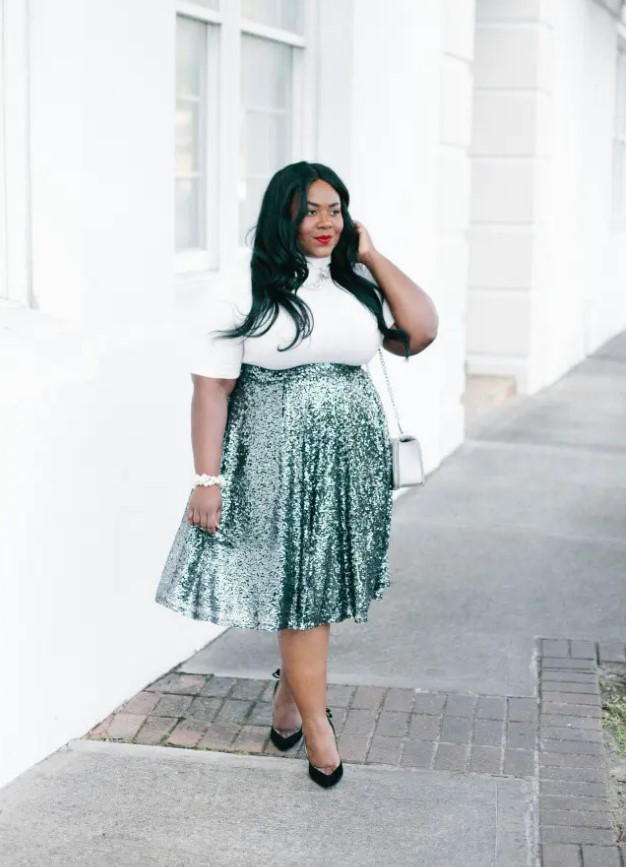 a white turleneck with short sleeves, a green high waist sequin midi, black shoes and an off-white bag