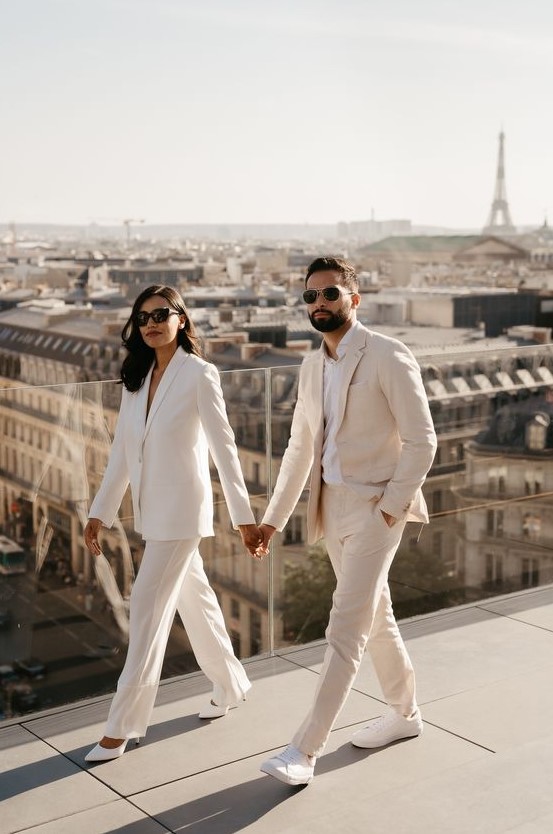 an elegant white wedding pantsuit with an oversized blazer and white heels for an adorable look