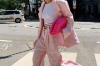 an oversized blush pantsuit, a white wrap up top, hot pink shoes and a clutch are a cool idea for a spring or summer wedding
