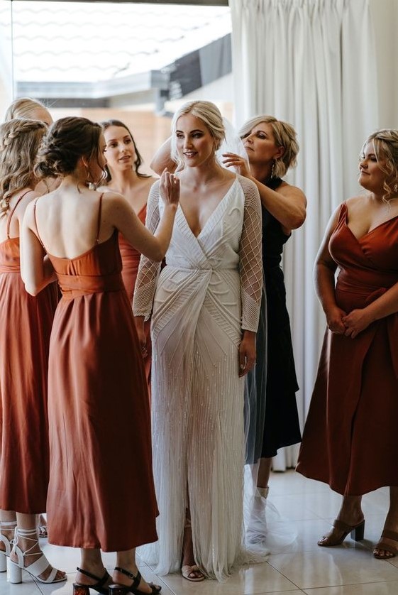 beautiful mismatching rust midi bridesmaid dresses with various necklines and looks plus mismatching heels for a trendy wedding