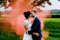 bright coral smoke highlighting the couple and creatign an ambience in the space