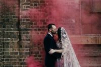 bright red smoke makes the wedding portrait more romantic and bold making a simple space magical
