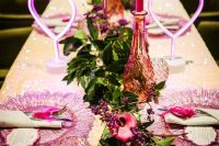 bright wedding table decor with pink neon hearts, fuchsia candles, pink candle lanterns, greenery and pink chargers