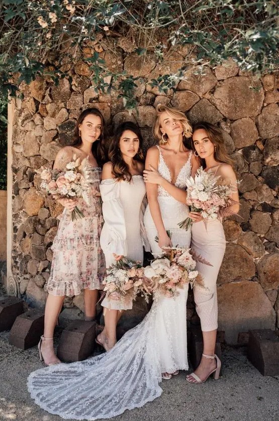 chic mismatching neutral bridesmaid dresses of midi length in blush and creamy plus nude shoes are spring or summer perfection