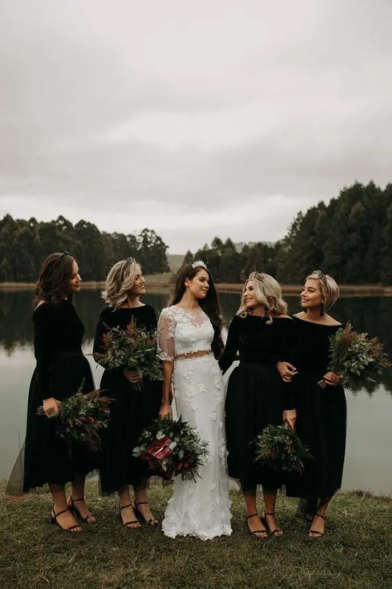 matching black midi bridesmaid dresses with bateau necklines, long sleeves and black shoes for Halloween