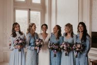 mismatching dusty blue printed and non-printed bridesmaid dresses of midi and maxi length, with long sleeves