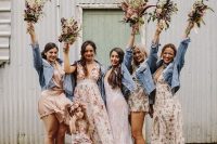 mismatching floral blush dresses and blue denim jackets for the bridal party are great for a boho wedding
