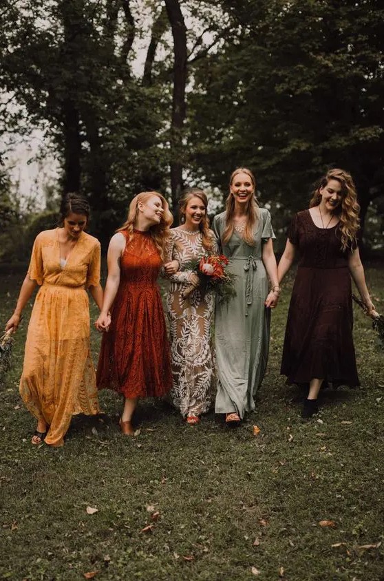 mismatching lace and plain bridesmaid dresses in yellow, rust, deep purple and sage green are adorable for a fall boho wedding