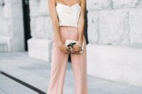 pink wideleg pants, a creamy spaghetti strap top, statement earrings, a small clutch with appliques for a casual summer wedding