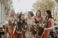 rust-colored midi silk slip bridesmaid dresses are a trendy idea thanks to their earthy tone