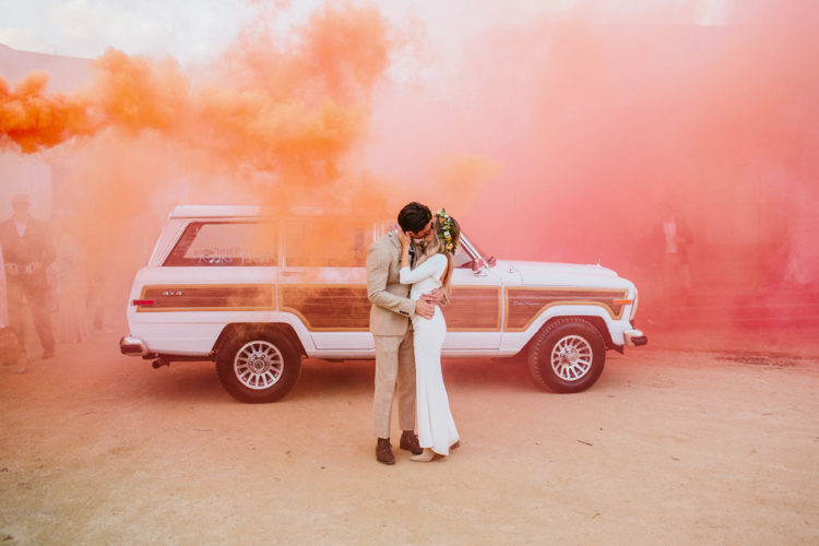 set the world on fire with orange and pink smoke as a backdrop for your wedding pic