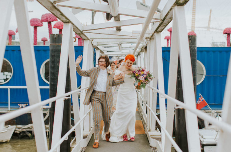 One bride was rocking a colorful striped suit, a white shirt and rust-colored loafers, the second girl was wearing an off-the-shoulder wedding dress and pink bow shoes