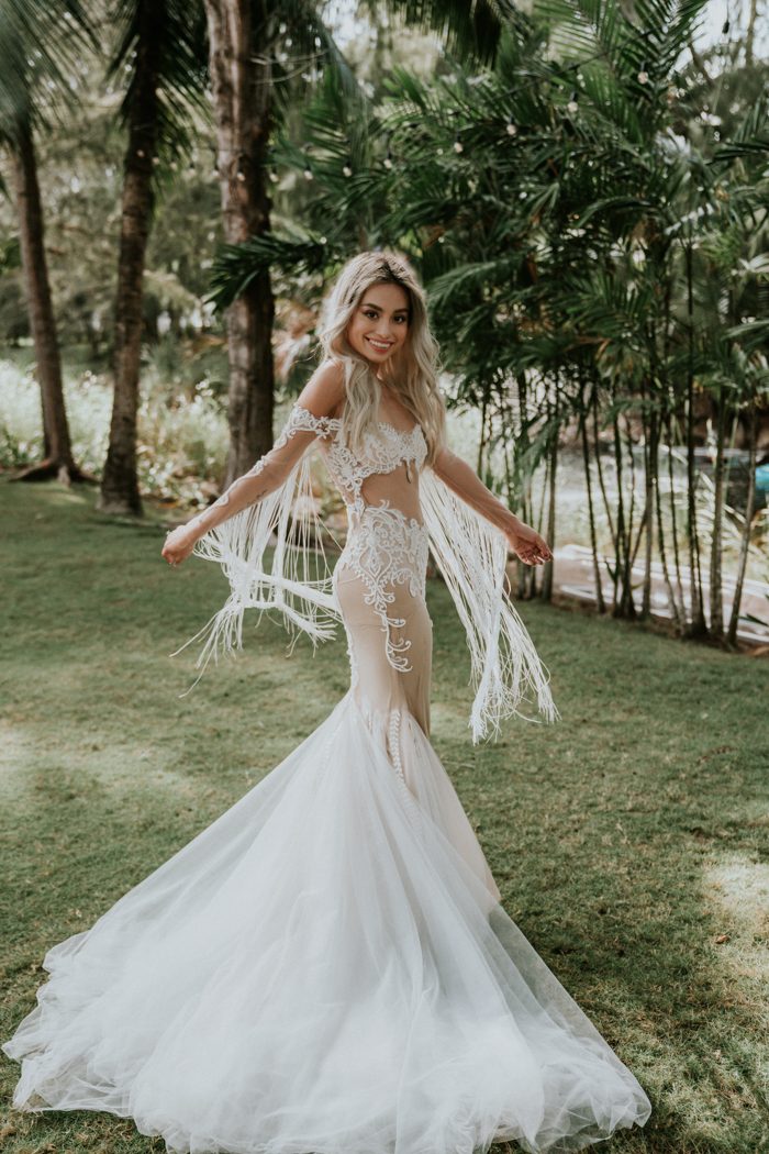 The bride was wearign a fantastic off the shoulder lace mermaid wedidng dress with fringe, a train and beading