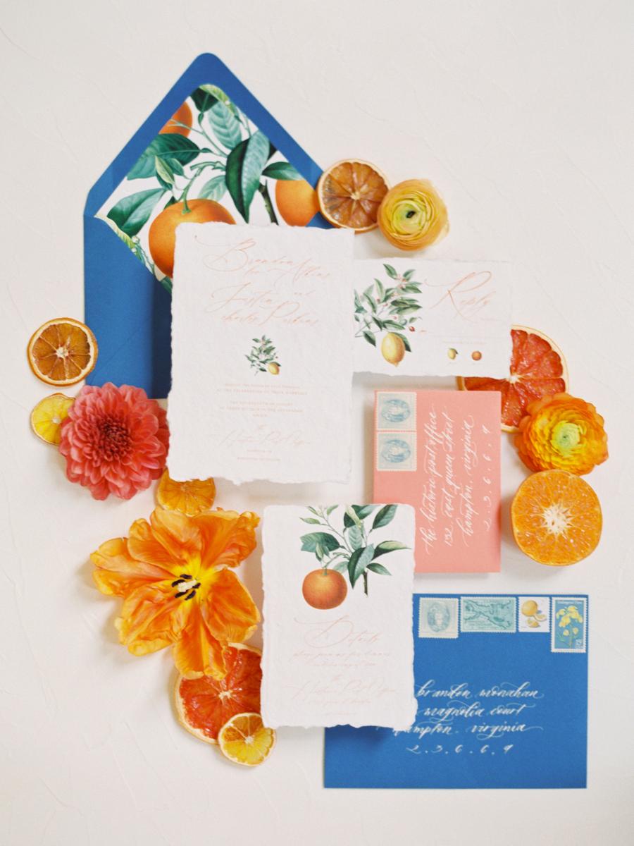 The wedding stationery was done in bright blue and coral pluus citrus prints