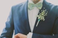 a trendy groom’s look in a navy suit