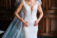 03 Her wedding dress with a plain sheath one with a lace bodice and detailing and a plunging neckline plus a train