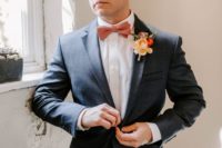 04 The groom was wearing a blue suit, a coral bow tie and a matching boutonniere