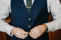 04 a navy blue suit with a waistcoat, a green snake print tie for a groom’s or groomsman’s look