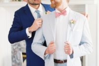 05 One groom was wearing a light blue suit with a coral bow tie and the other groom was wearign a bold blue suit with a light blue tie