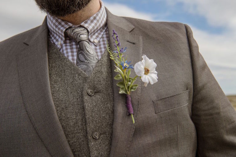 The groom was wearing a grey three piece suit with a woolen waistcoat and a printed shirt