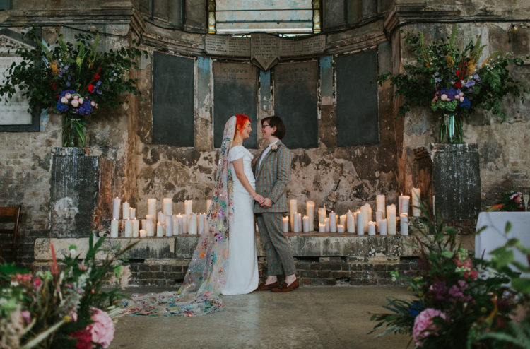 The wedding ceremony space was done with lots of pillar candles and lush and bold florals