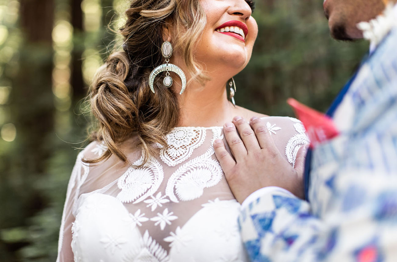 The bride accessorized her look with statement earrings