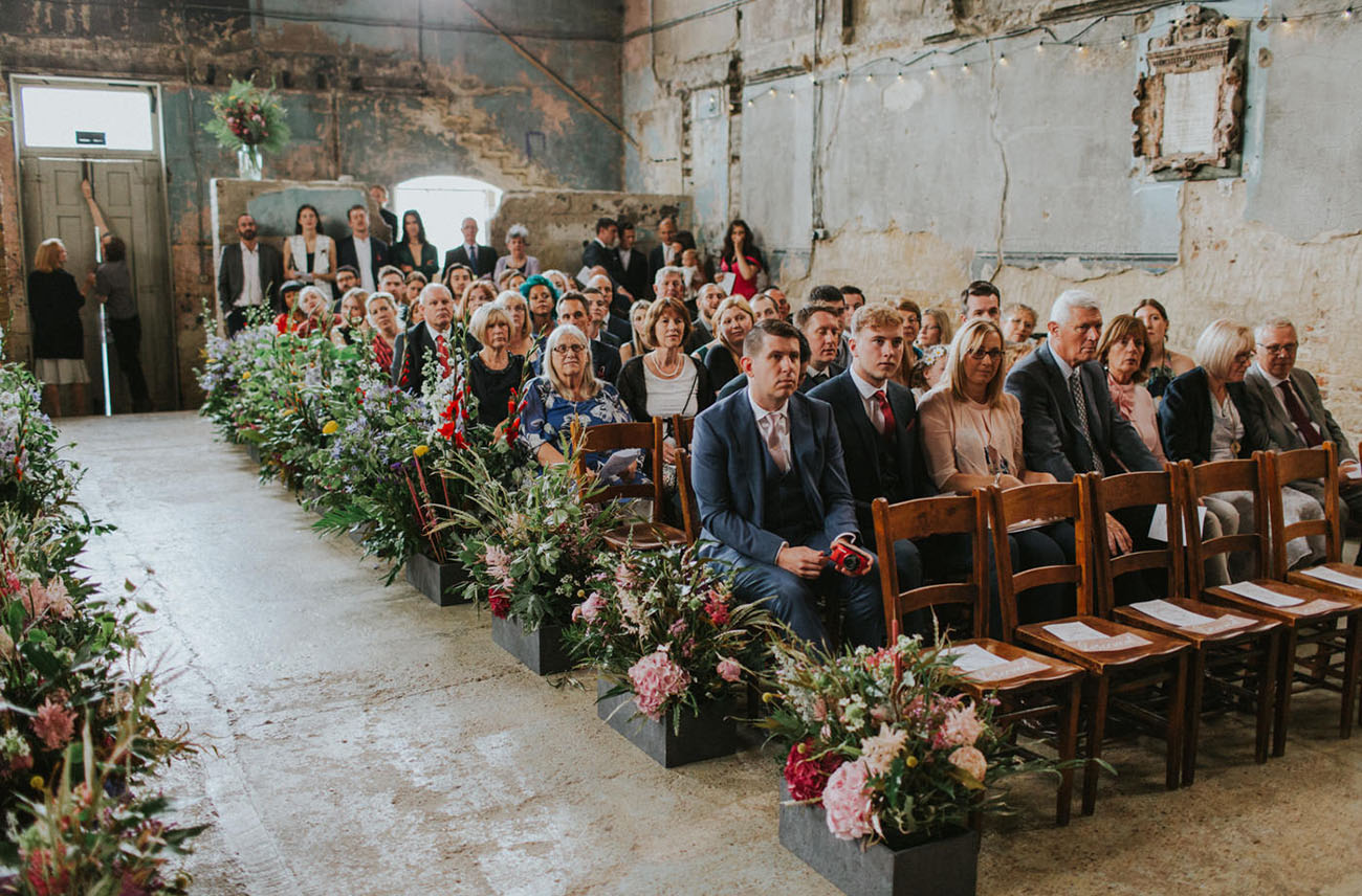 The wedding aisle was lined up with lush florals and lots of greenery