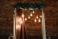 06 a chic wedding arch with a copper curtain, bulbs hanging down, greenery, candle lanterns and cacti in pots