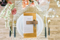 07 Each place setting was done with a fabric placemat, some elegant cutlery and chic rust and coral blooms