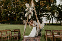 07 The second wedding arch was decorated with neutral blooms, pampas grass and foliage