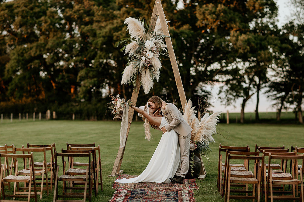 The second wedding arch was decorated with neutral blooms, pampas grass and foliage