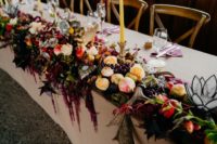 08 Lush abundant table runners with cascading blooms, greenery, antlers and fruits and candles were amazing
