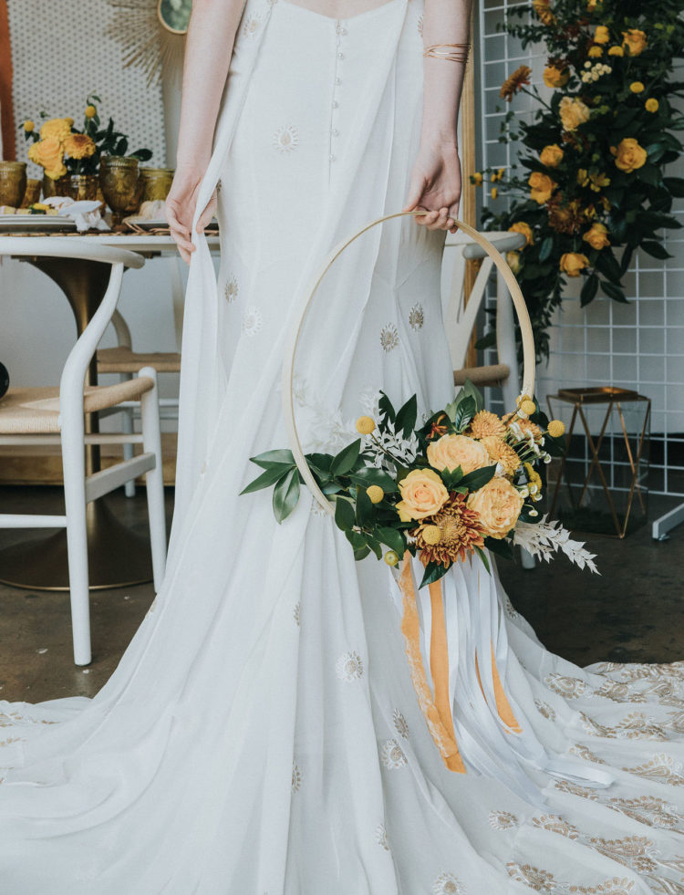 The wedding bouquet was made of a hoop and mustard and yellow blooms and foliage